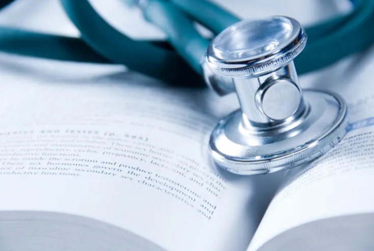 Stethoscope on top of a textbook