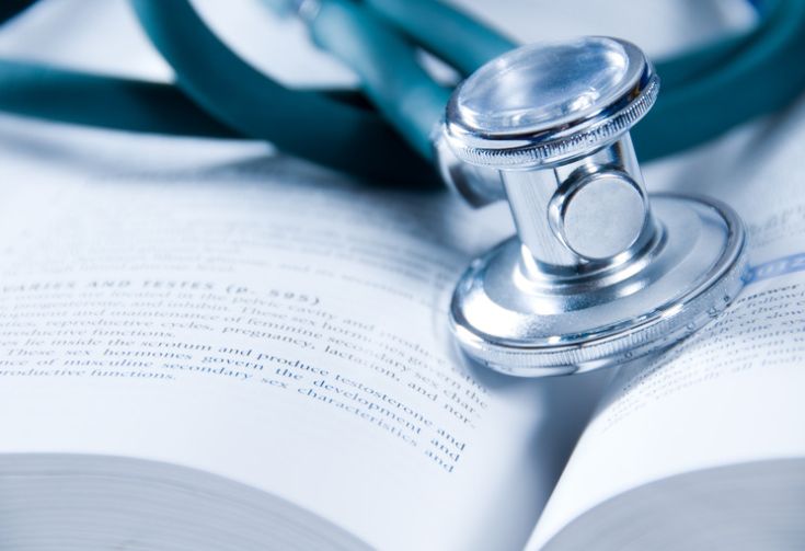 Stethoscope on top of a textbook