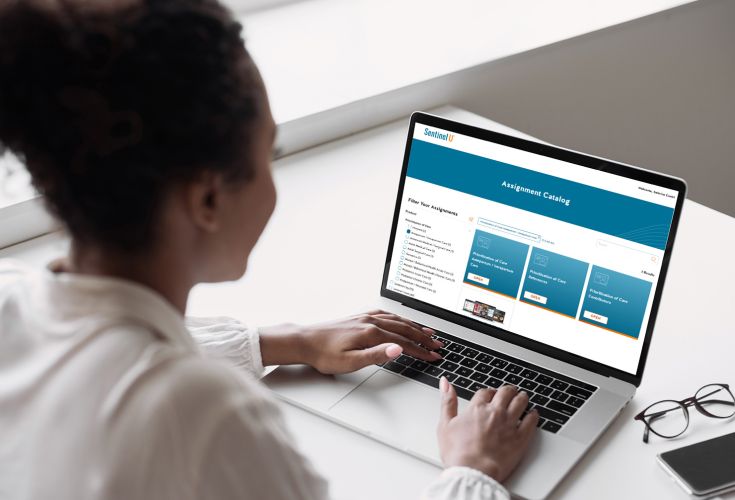 Woman using Sentinel U Assignment Catalog on a laptop